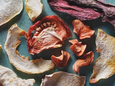 Different dried vegetables on green background